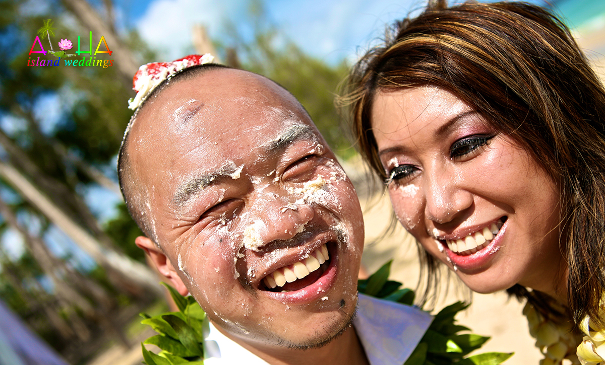 epic cake fight on the beach after the ceremony